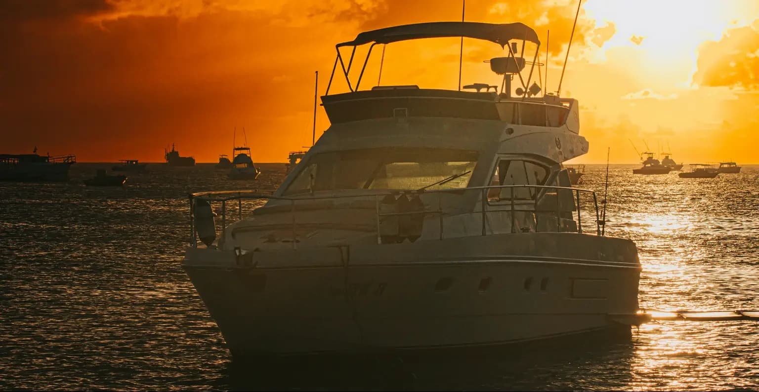 Motor yacht at anchor during a golden sunset